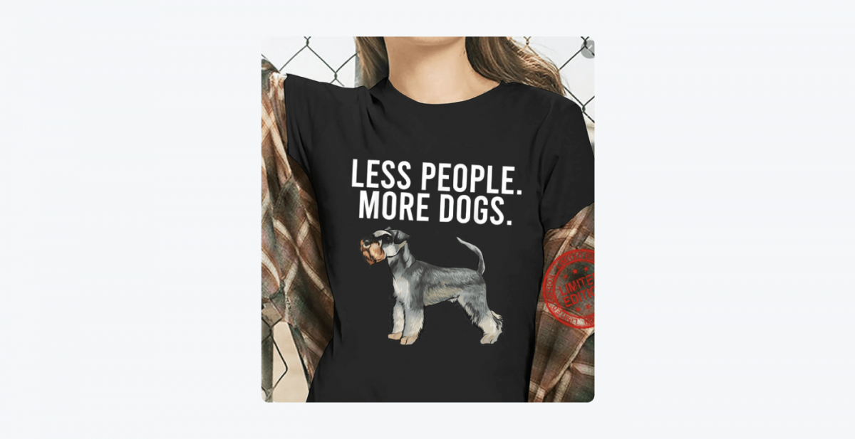 Picture of a woman wearing a t-shirt with "Less people. More dogs." written on it