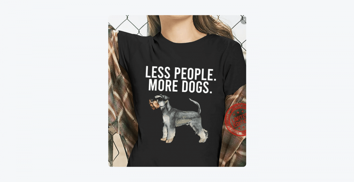 Picture of a woman wearing a t-shirt with  "Less people. More dogs." written on it